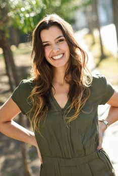 Portrait of a pretty woman smiling in a urban park