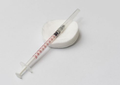 Medical treatment vaccine and syringe for injections on a white background. Prevention and treatment of coronary infection. Medicine is an infectious concept.