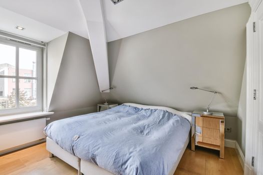 Bedroom with a large soft bed and a window