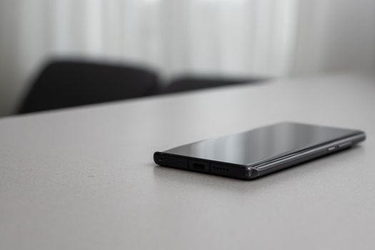 A single mobile phone on gray table