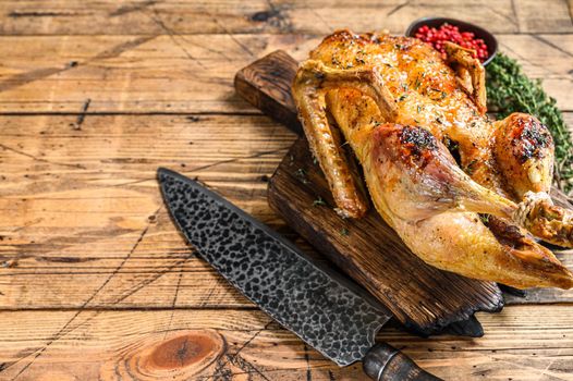 Christmas Baked whole goose with herbs. wooden background. Top view. Space for text.