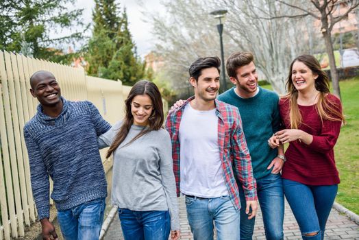 Group of multi-ethnic young people having fun together outdoors in urban background