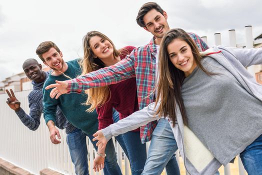 Group of multi-ethnic young people having fun together outdoors in urban background