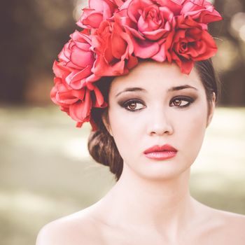 Close-up portrait of young beautiful japanese woman with pink and red flowers, model is an asian beauty