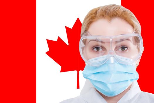 Masked little girl looking at the camera on flag Canada background. The concept of attention to the worldwide spread of the coronavirus worldwide. Coronavirus, virus in Canada.