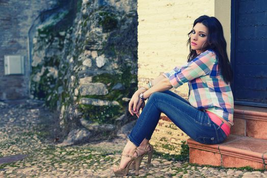 Portrait of a young beautiful woman in a urban background