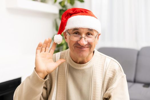 old age, holidays, problem and people concept - senior man in glasses thinking at home over christmas tree background.