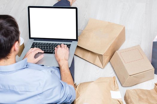 Back view of male person sitting front open laptop computer with blank empty screen for your information or content, modern businessman working in internet via notebook,student at coffee shop learning