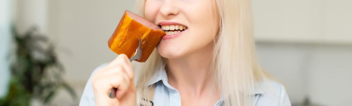 Attractive Young Woman Holding a Sausage on a Fork