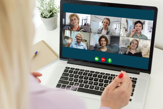 Virtual meeting online. Video conference by laptop. Online business meeting. On the laptop screen, people who gathered in a video conference to work on-line.