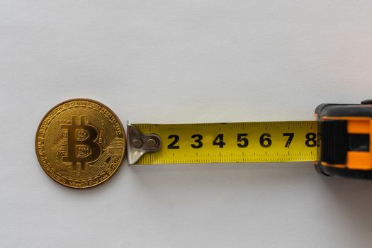 golden crypto coin in tape measure. High quality photo