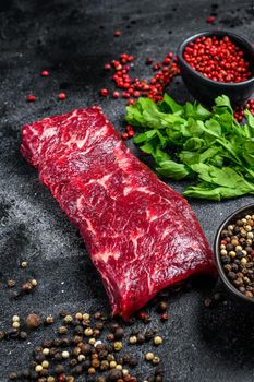 Raw marble beef meat steak. Black background. Top view.