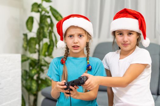 two little girls with a joystick playing a video game