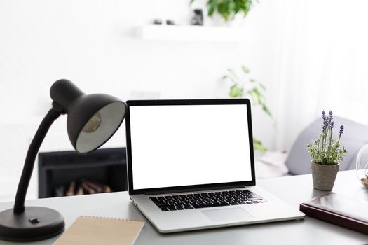 Laptop with blank screen on table