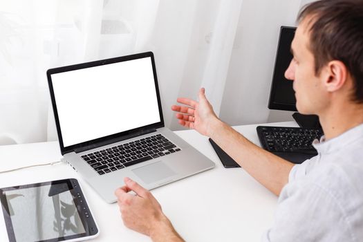 Back view of male person sitting front open laptop computer with blank empty screen for your information or content, modern businessman working in internet via notebook,student at coffee shop learning