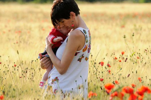 Mother and daughter in a poppy field together