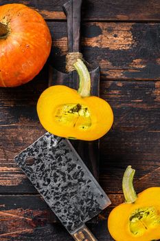 Raw orange pumpkins. Dark wooden background. Top view.