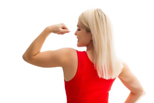Athletic young woman pumping up her muscles on a white background