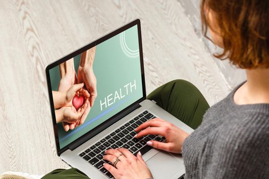 Doctor entering patient notes on a laptop in surgery