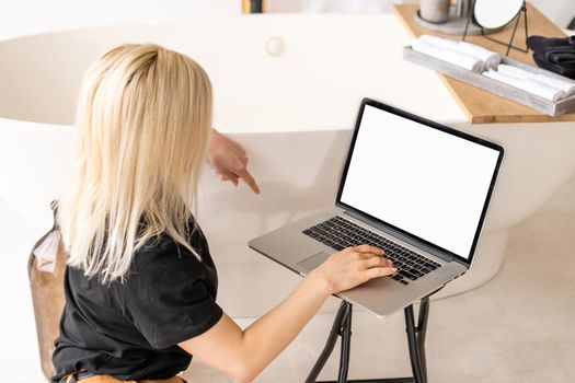 Rear view of business woman hands busy using laptop at office desk, with copyspace.