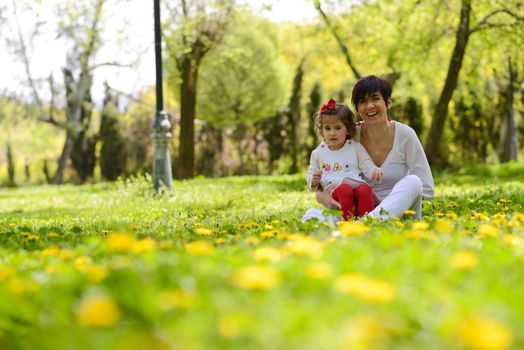 Portrait of mother and little girl playing in the park