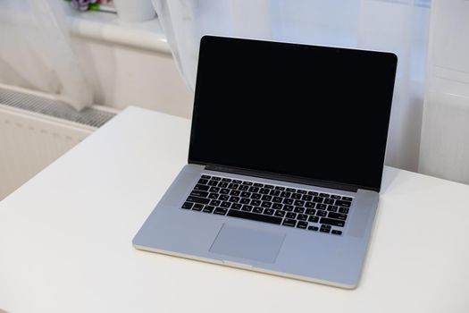 Computer mockup white background on table. Laptop with blank screen. High quality photo