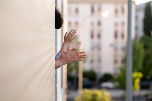 People in Spain clapping in the window in support of people who fight against the coronavirus