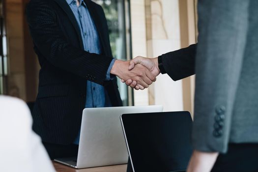 Businessman and partner handshake for the new agreement after sign in agreement contract with work together