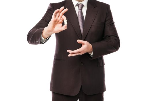 Business risk concept - businessman in suit throwing dices isolated on white background