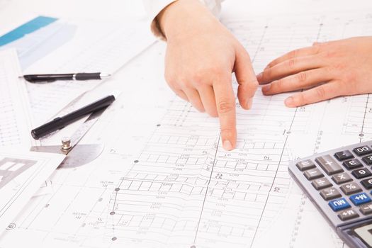 construction graph on background of businessman hands with pens white