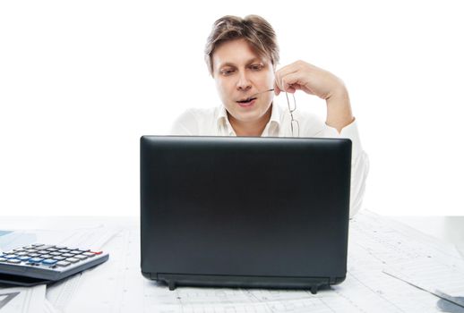 Portrait of thinking young office worker with laptop isolated on white