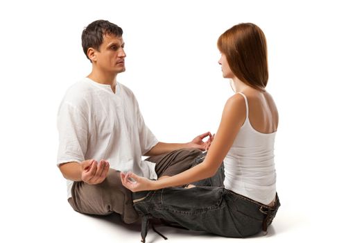 Young healthy couple in yoga position on white background