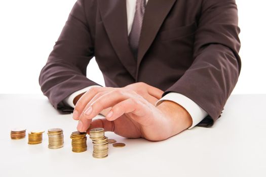 Business man calculating profit - closeup shot of hands counting coins isolated over white