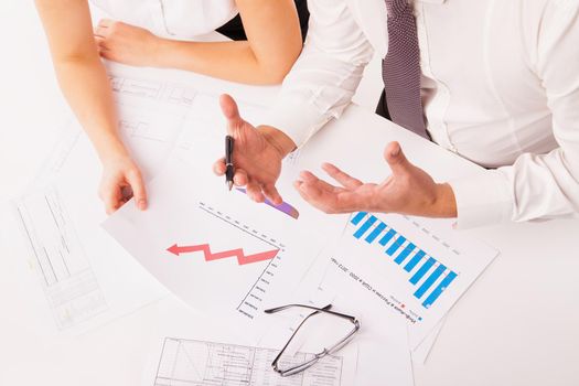 Close up of businessman and businesswoman planning or discussing in office around the table isolated on white background