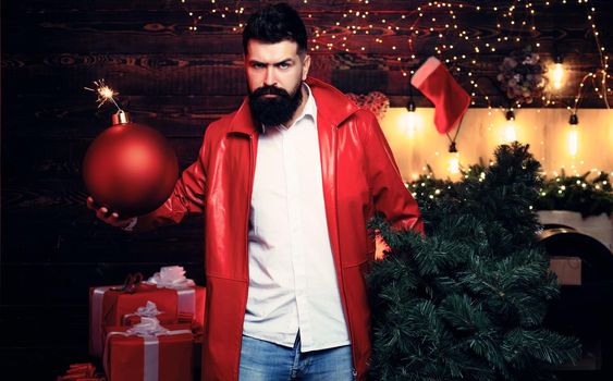 Hot Party Christmas. Christmas man in fashion red dress hold bomb. Christmas sale. Bearded handsome man, Santa Claus with beard