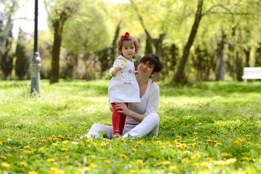 Portrait of mother and little girl playing in the park