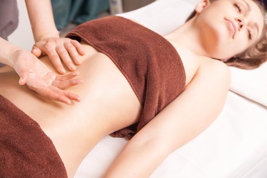 Woman enjoying a Ayurveda oil massage treatment in spa