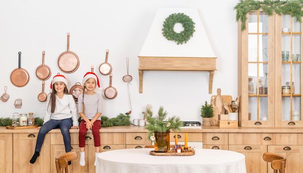 two little girls are waiting for christmas at home