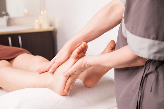 Foot massage for a woman in a luxury spa