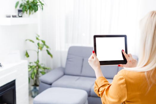 Business woman holding blank touch screen device.