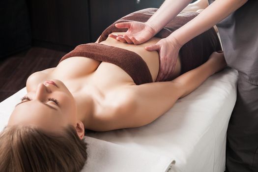 Woman enjoying a Ayurveda oil massage treatment in spa