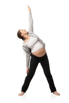 Beautiful pregnant woman smiling and doing exercises isolated