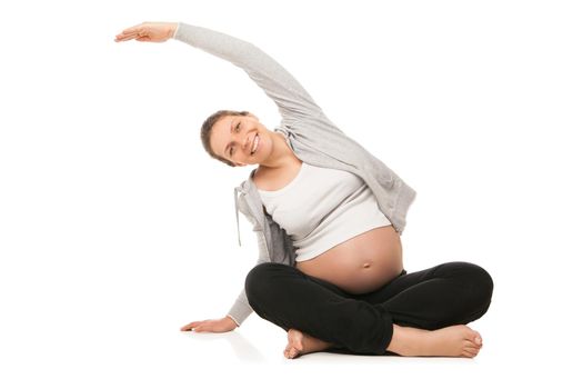 Beautiful pregnant woman smiling and doing exercises isolated