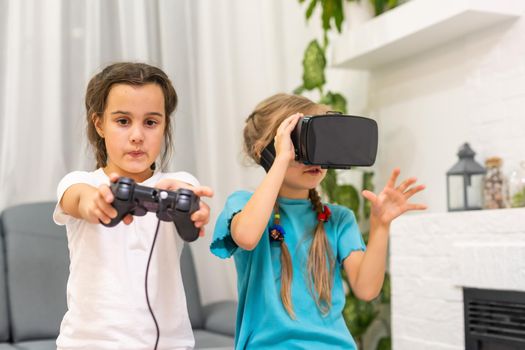 two little girls using glasses of virtual reality headset. concept of modern technologies