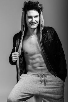 Portrait of athletic man wearing hoodie jacket. Studio shot