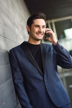 Portrait of an attractive young businessman on the phone in an office building