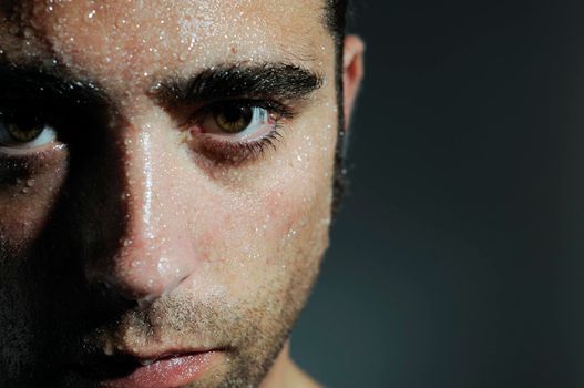 Closed portrait of a man with water drops