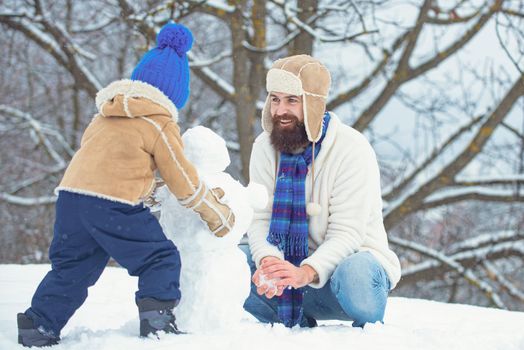 Winter, father and son play outdoor. Merry Christmas and Happy new year