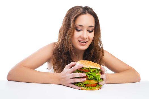 Happy Young Woman Eating big yummy Burger isolated on white background