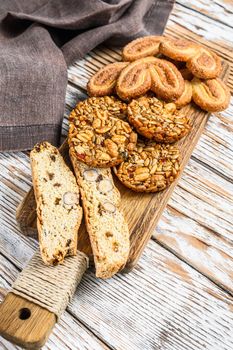 Mix of sweet cookies with glass of milk. white wooden background. Top view